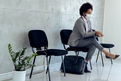 Woman waiting in lobby for her interview, sitting on a chair.